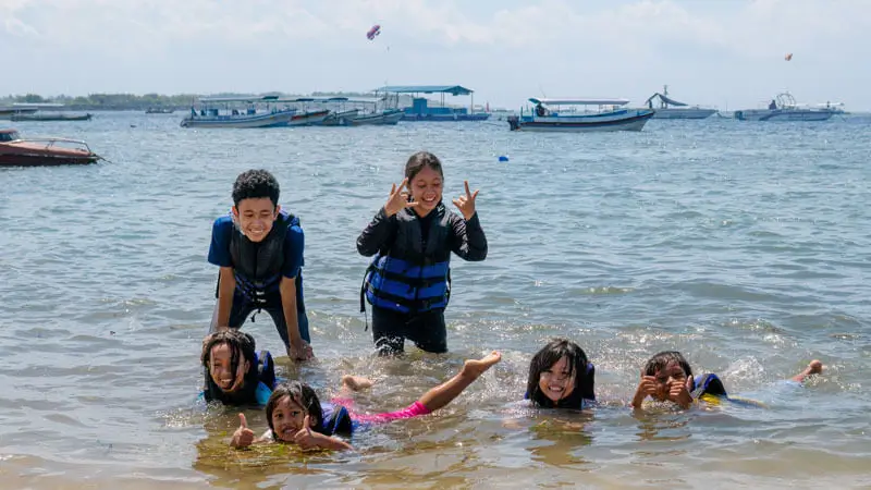 Kids enjoying water play in Bali at Tanjung Benoa Beach.