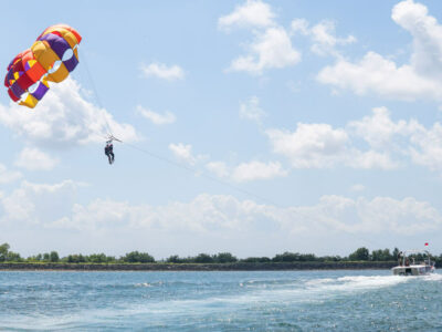 Parasailing participants enjoyed views of the blue sea above Tanjung Benoa, Bali. FAQ Parasailing Bali