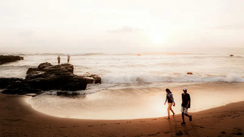 Visitors enjoy the sunset view at shoreline