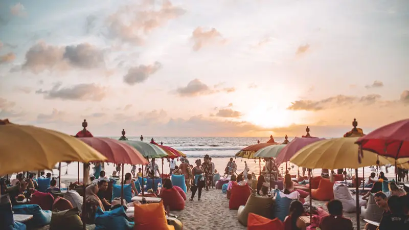 Visitors enjoy the sunset atmosphere at on of the beach club