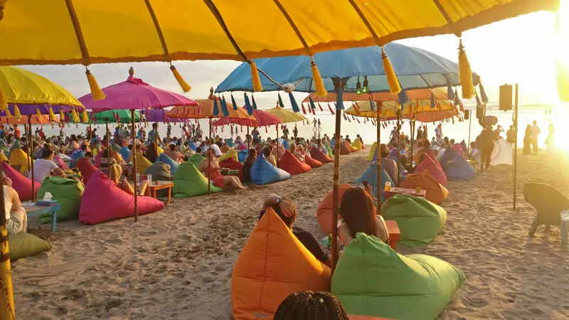 Visitors enjoy the sunset at the beach club