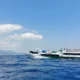 A fast boat speeding across the clear blue waters from Bali to Gili Trawangan.