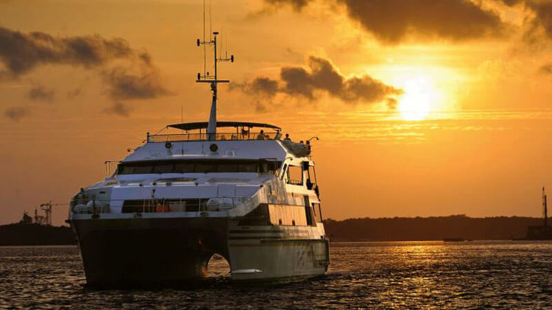 Luxurious cruise ship sailing at sunset for a dinner cruise in Benoa Harbor, Bali