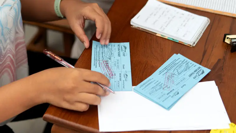 Person holding Gili Trawangan fast boat tickets for check-in