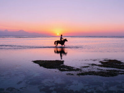 Gili Trawangan sunset with horse rider silhouette.