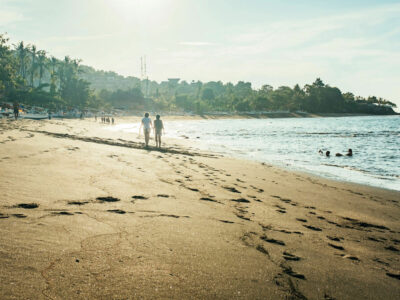 Serene beachscape with footprints in sand at dawn in East Bali