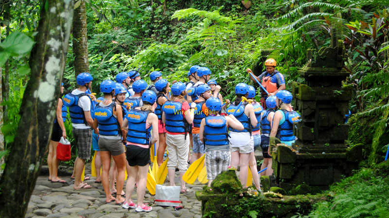 Group of rafters receiving safety briefing in Bali's lush jungle