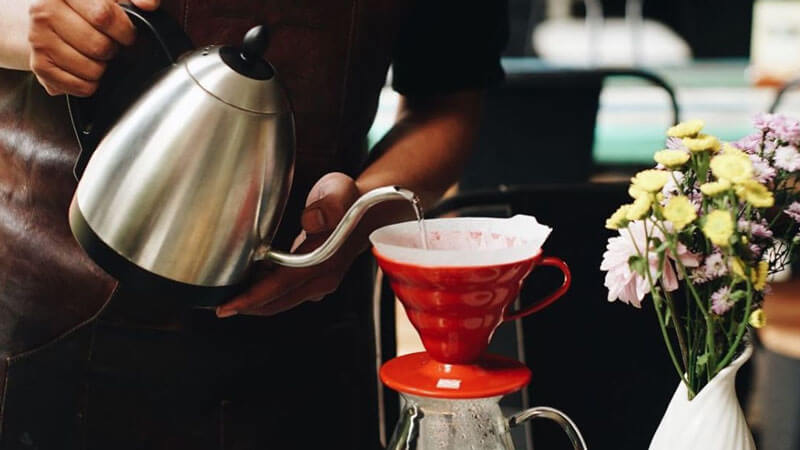 Precision pour-over brewing at The Coffee Library Kayu Aya.