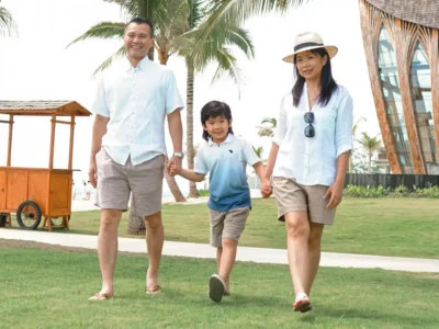 Happy family walking in the park of Legian beach resort, Bali