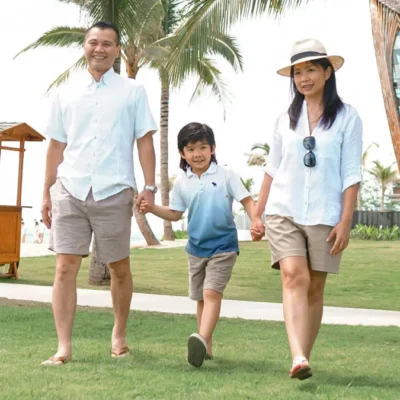 Happy family walking in the park of Legian beach resort, Bali