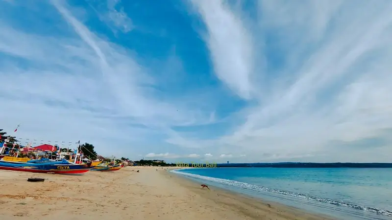 Jimbaran Beach with white sand, blue sky and clear sea water