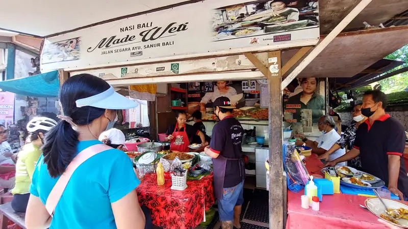 Tourists enjoy local dishes at Warung Nasi Campur Men Weti, Sanur, Bali