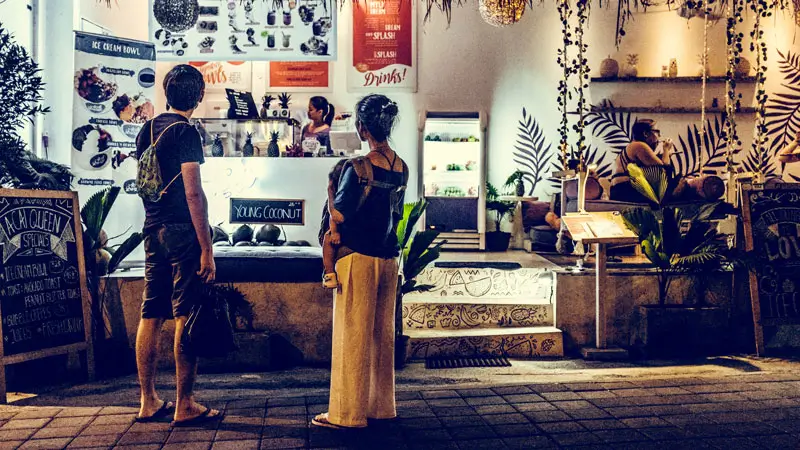 Tourists enjoy a safe night atmosphere one of the Attractions in Ubud for a Family Vacation