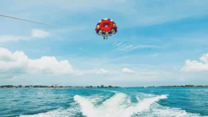 Adventurers enjoying parasailing in Bali’s clear blue waters.