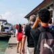 Tourists prepare to board a fast boat at Padang Bai Harbor