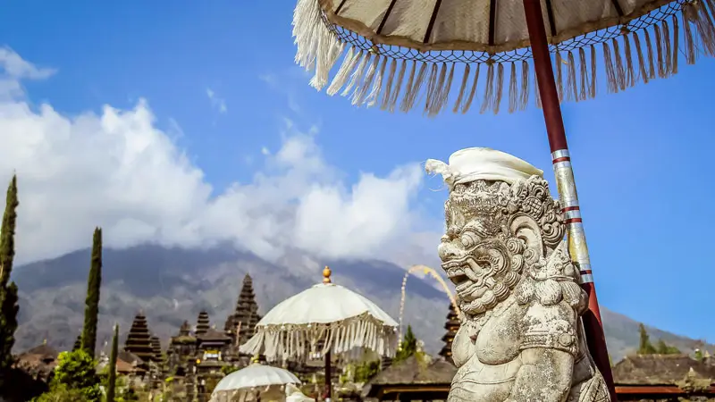 Guardian statue at Besakih Temple with Mount Agung in the background