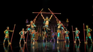 Bali performers executing a dynamic stick dance from Java with traditional costumes and synchronized choreography. Image Credit: © Devdan