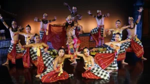 Bali performers presenting a traditional Kecak dance scene with intricate costumes and dramatic choreography. Image Credit: © Devdan