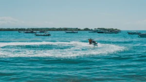 Visitors enjoy the excitement of riding a Jet Ski in Tanjung Benoa Bali with a view of the blue sea.