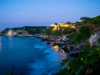 Dusk view of Uluwatu’s illuminated cliffs overlooking the ocean, Bali.