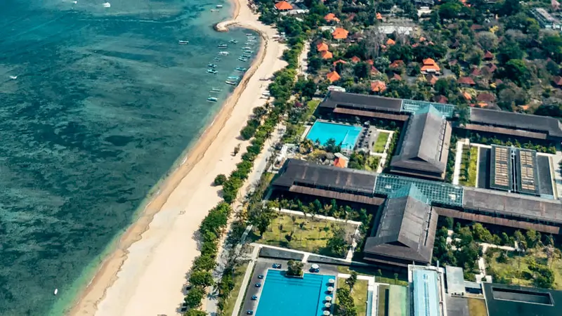 Aerial view, showcasing beachfront accommodations and coastline.