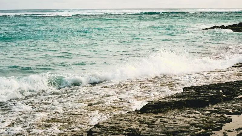 Waves crashing on the rocky shoreline Bali.