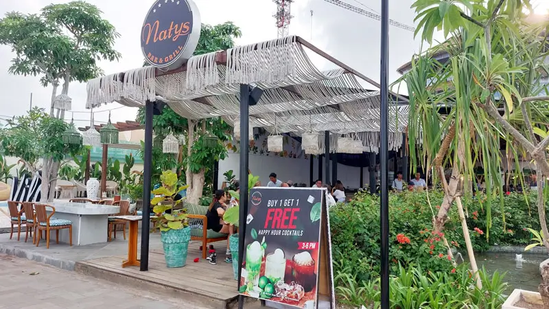 Outdoor dining area at a tropical-themed restaurant in Sanur Shore.